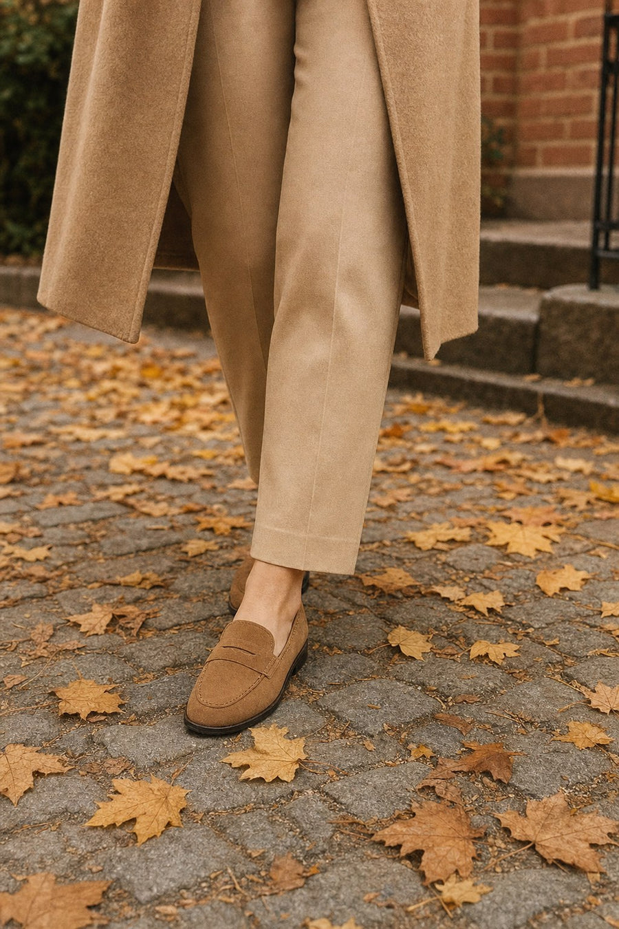 Woman wearing suede loafers on an autumn street